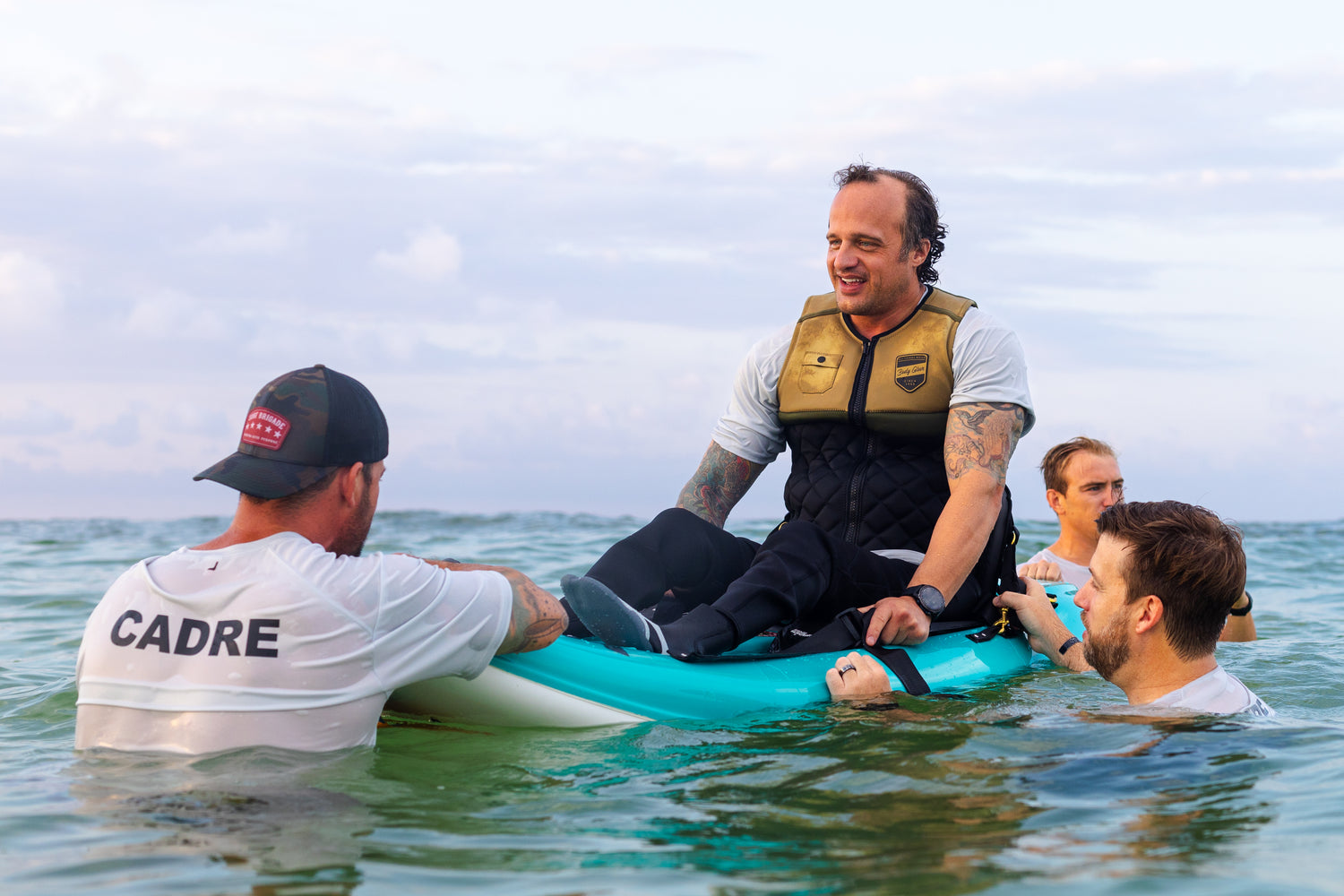 Adaptive veteran surfer with instructors in the water